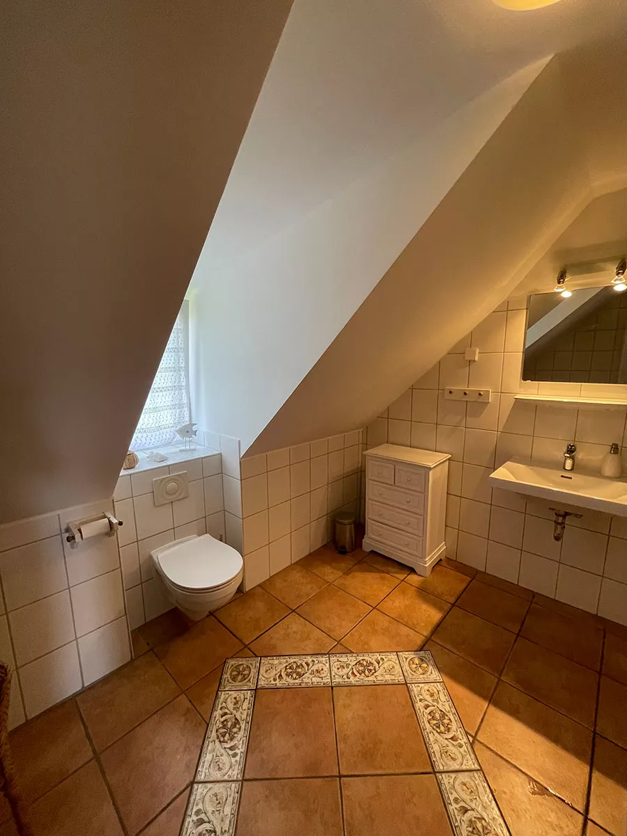Ferienhaus Deichsonne – Badezimmer im Dachgeschoss mit WC und Waschbecken Ferienhaus Deichsonne – Badezimmer im Dachgeschoss mit WC und Waschbecken